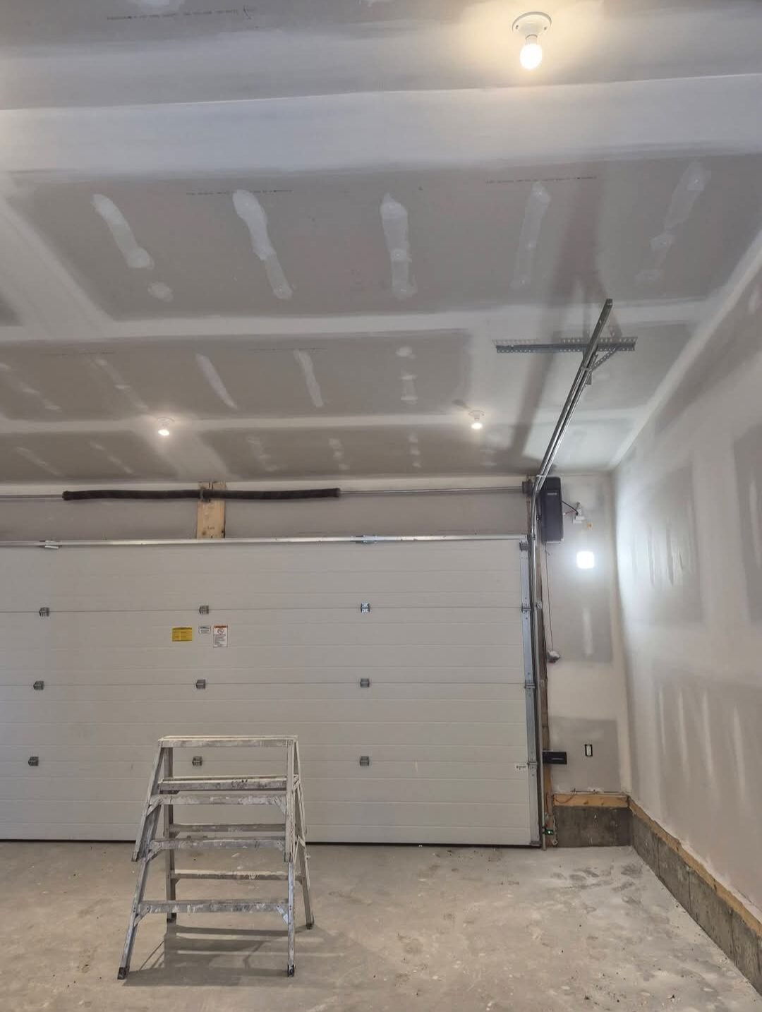 Anderson Renovations — Finished garage with drywalled ceiling and walls