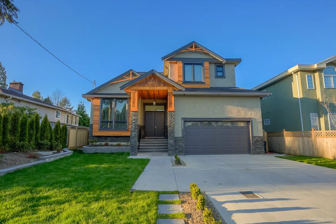 By Design Construction Inc — Home exterior with garage