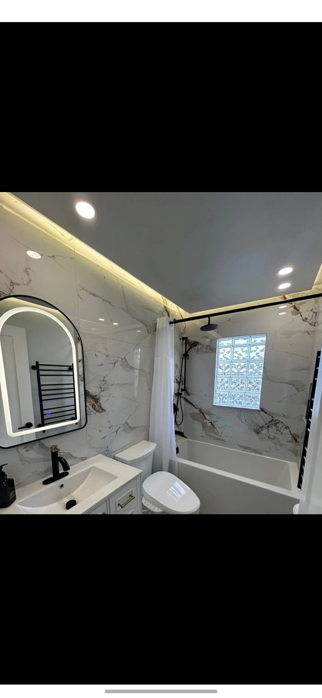 Bergen Renovation — after: Bathroom renovation — dated tub surround transformed into a marble walk-in shower