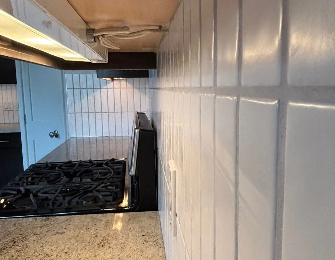 Bergen Renovation — Precision tile backsplash with crisp, straight grout lines