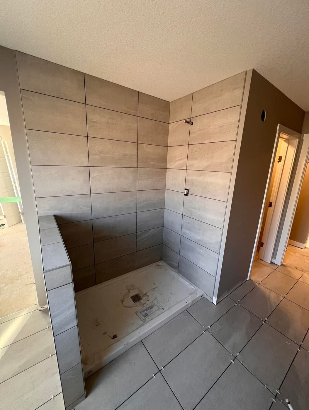 Ceramic Service Professional — Walk-in shower tiled in wood-look porcelain, in progress