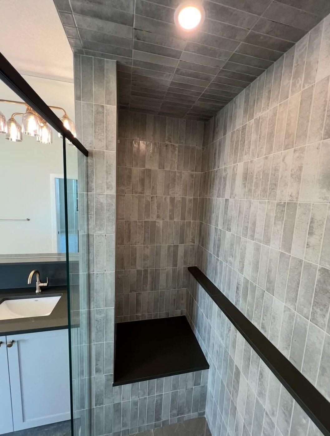 Ceramic Service Professional — Tiled walk-in shower with built-in bench