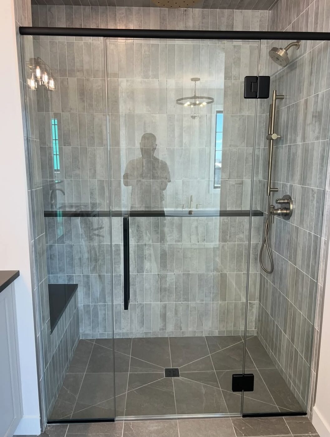 Ceramic Service Professional — Finished glass walk-in shower with grey tile and bench seat