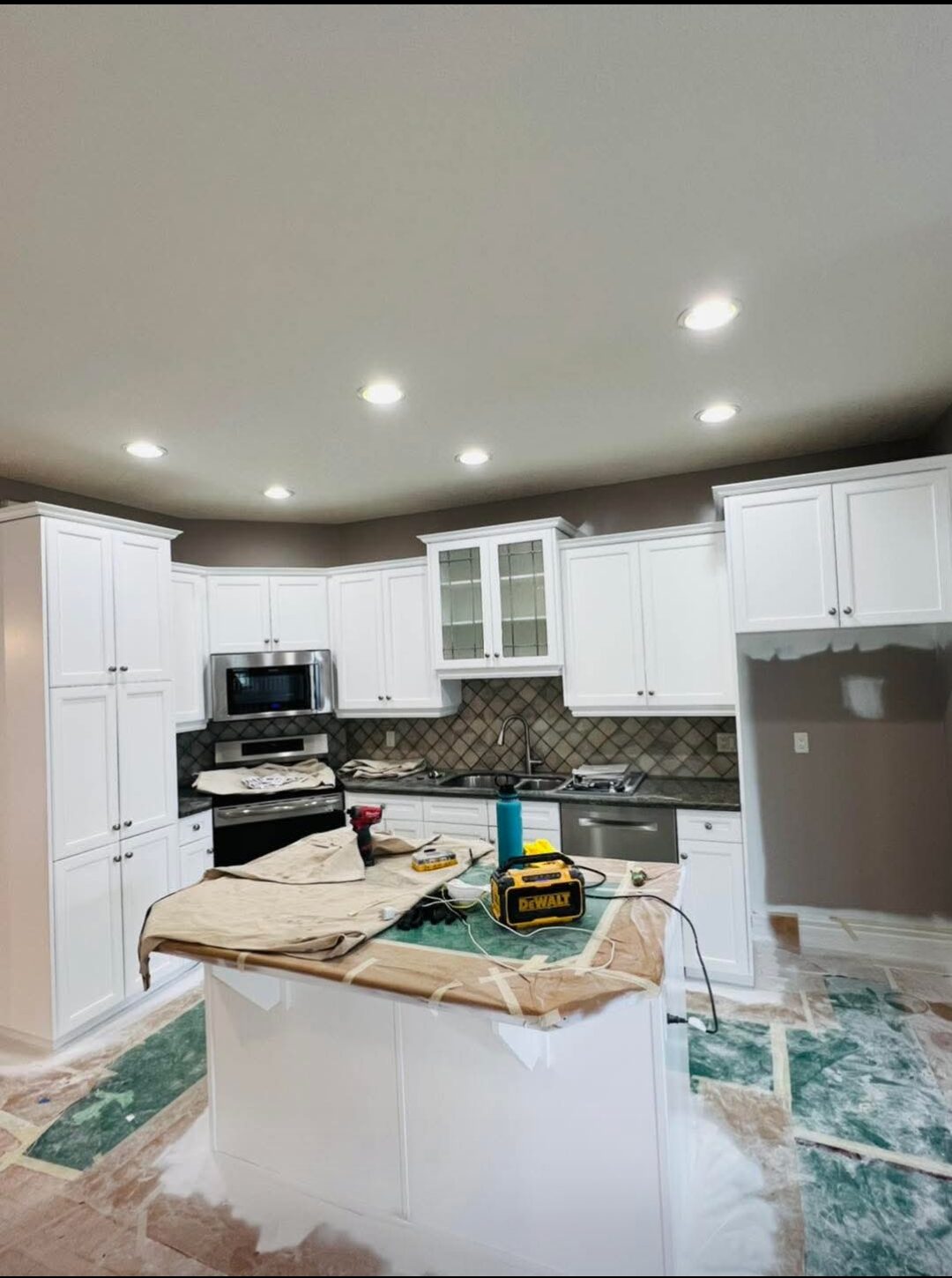 Euro Brothers Painting Calgary — Kitchen cabinets repainted crisp white
