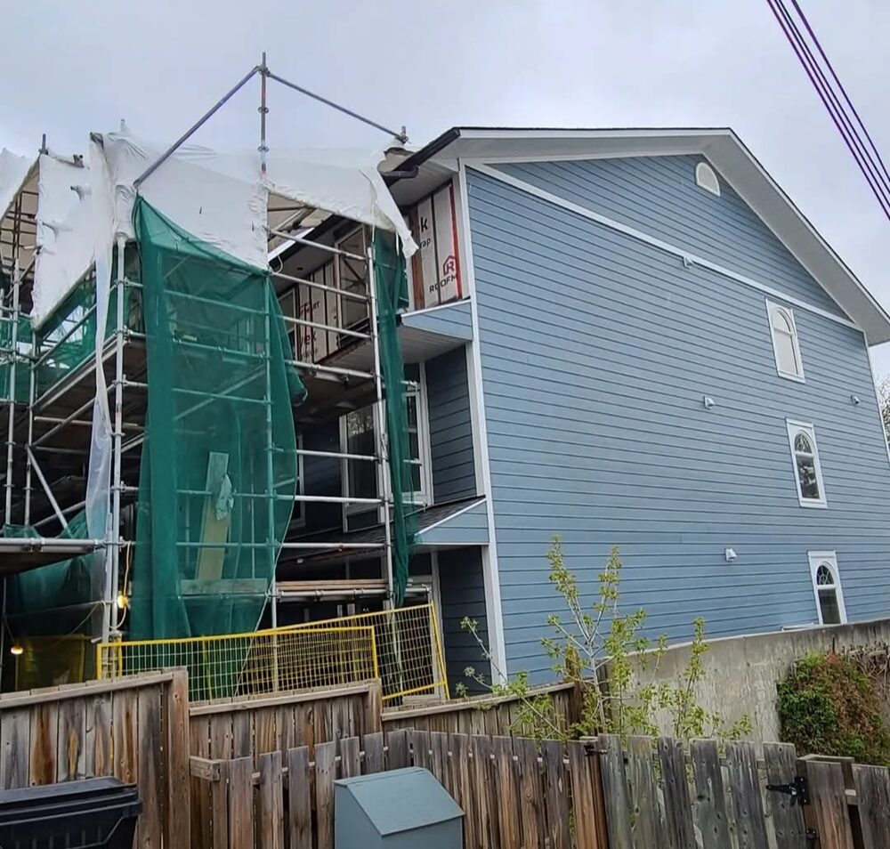 Exterior Outfitters Ltd. — Siding replacement in progress under covered scaffolding