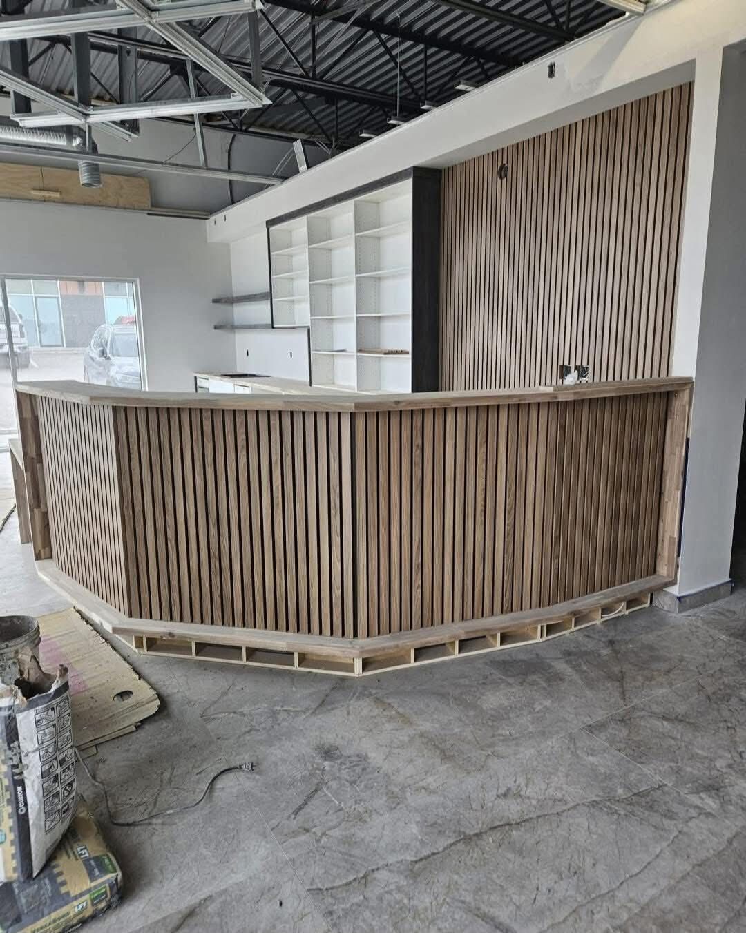 Gosur Development Inc. — Curved wood-slat reception desk build-out
