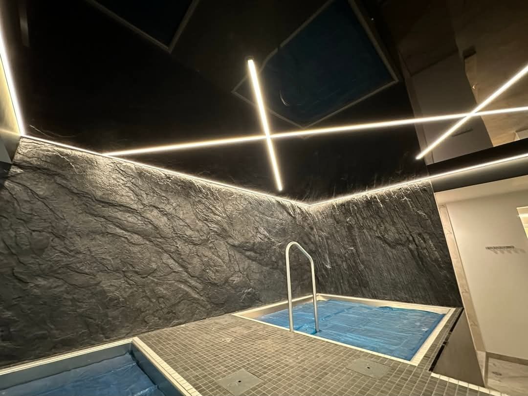 Gosur Development Inc. — Cold-plunge pool area with textured stone feature wall
