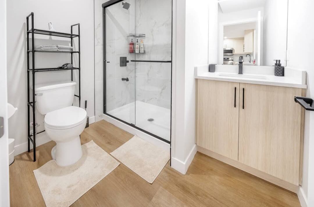 EliteCity Construction Ltd. — Basement bathroom with glass shower and vanity
