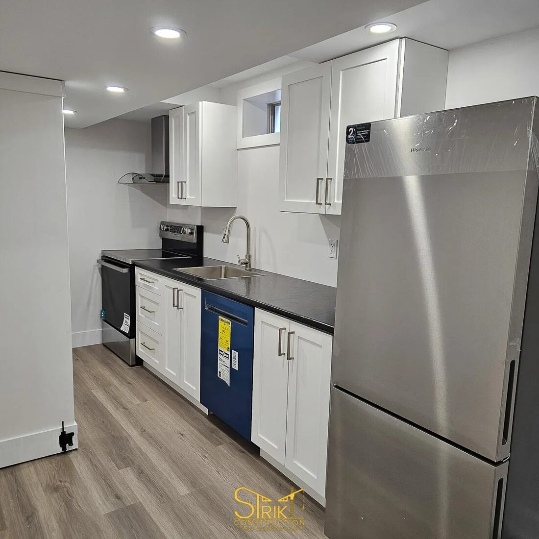 Strikt Construction and Renovation — Kitchen with island