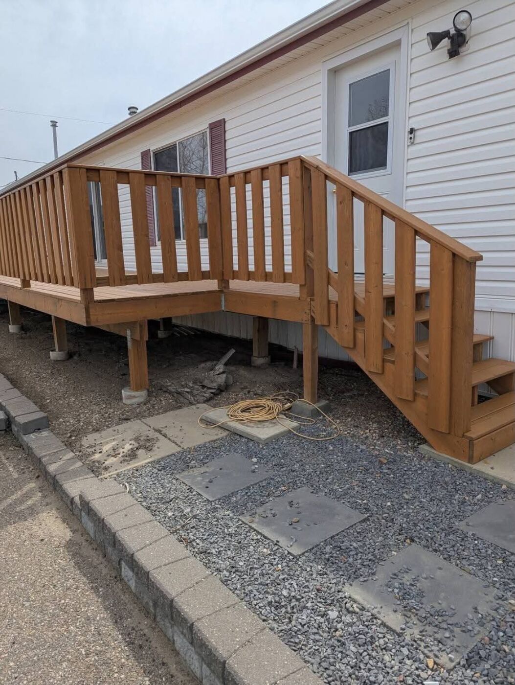 Done Right Renovations — New wood deck with railing and staircase