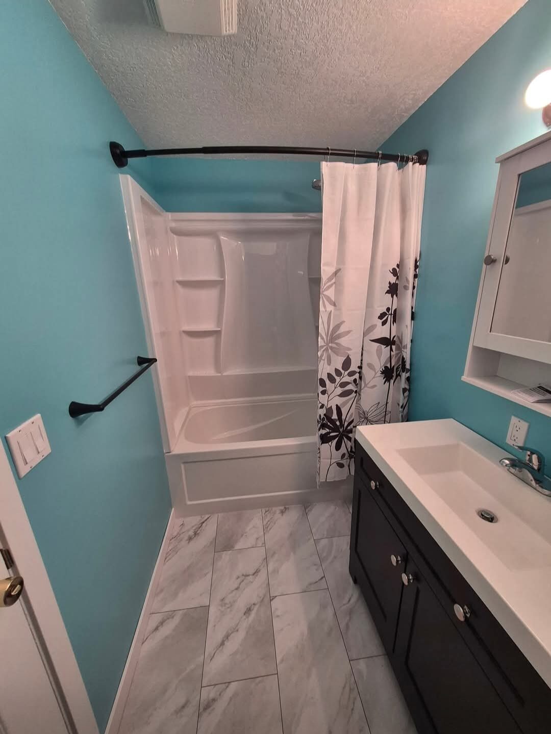 Garret's Handyman & Renovation Services — Bathroom renovation with tub-and-shower surround and new vanity