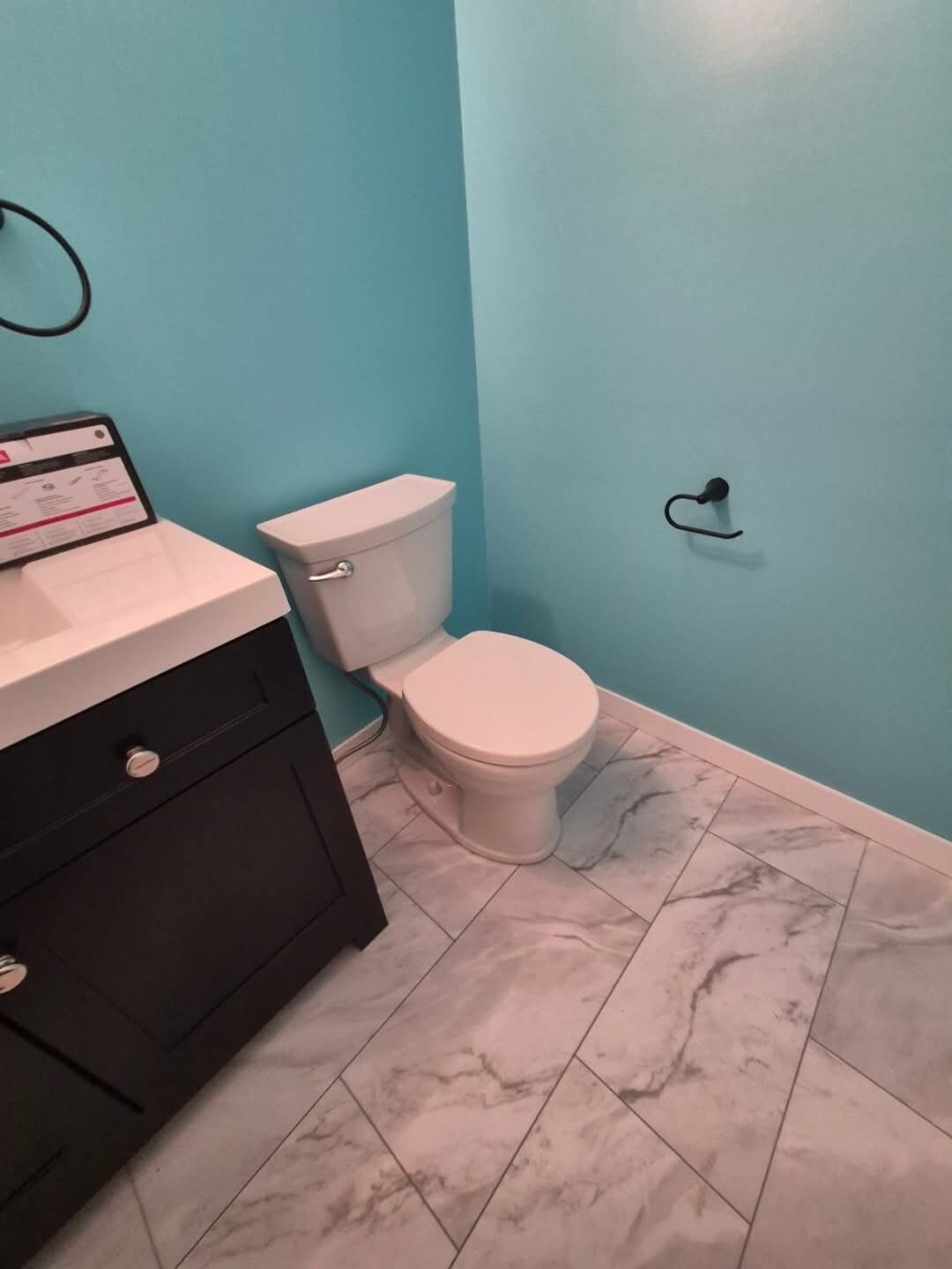 Garret's Handyman & Renovation Services — Bathroom remodel with new toilet, vanity and tile floor