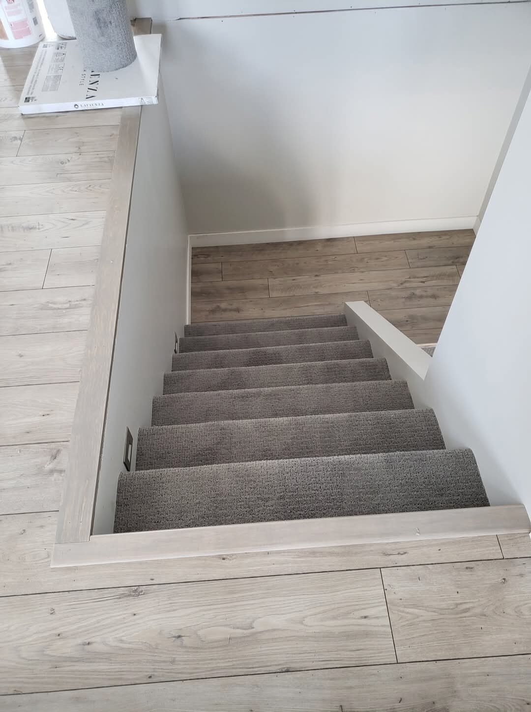 Garret's Handyman & Renovation Services — Staircase with new carpet runner and laminate flooring