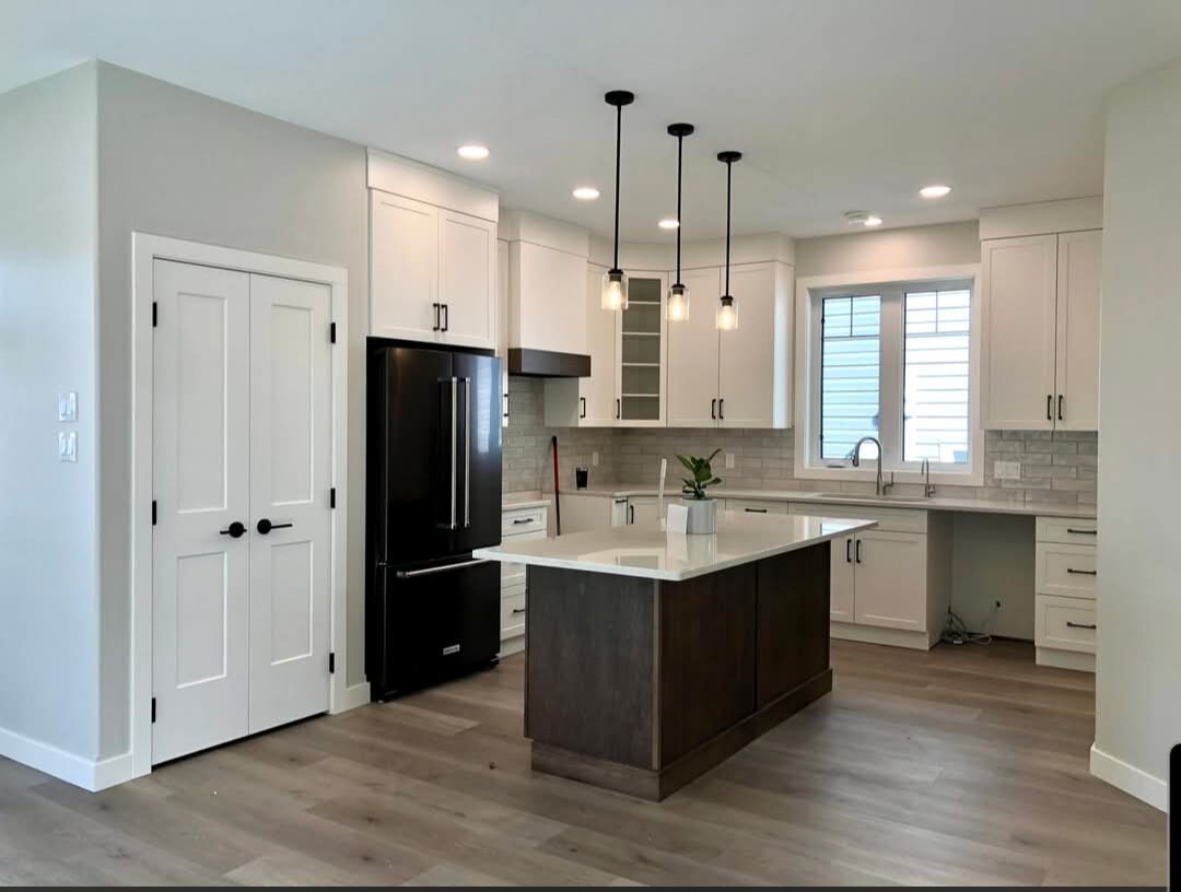 Genica Custom Builders — New custom kitchen with quartz island and pendant lighting
